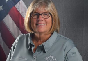 Portrait of Commissioner Hathaway in front of American flag backdrop